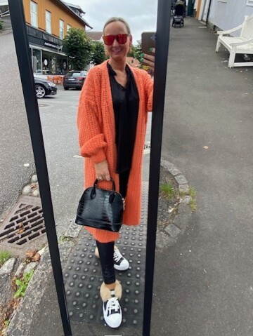 Orange cardigan.